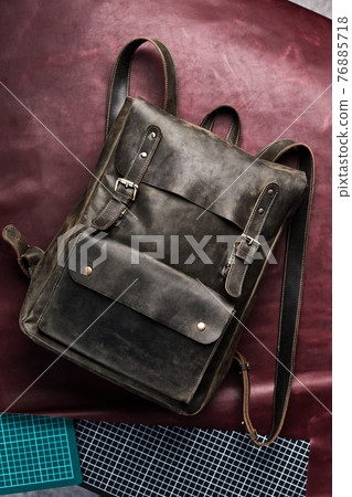 Leather Backpack accessories isolated hipster background. brown leather bag. Hand made backpack for travelers. 76885718