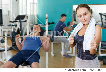 Portrait of positive sporty girl in gym 76885878