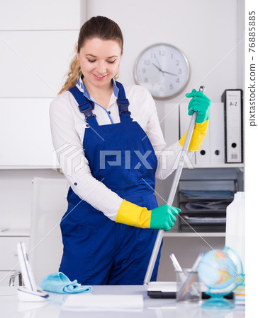 Young girl cleaning the room with mop Young girl cleaning the room with mop 76885885
