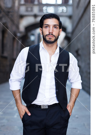 Waist up portrait of man against old castle Waist up portrait of man against old castle 76885891