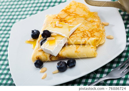Crepes with brie and honey Crepes with brie and honey 76886724