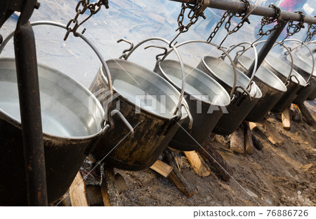 Preparation of food in boilers on an open fire in a traditional style Preparation of food in boilers on an open fire in a traditional style 76886726
