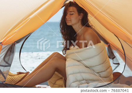 Naked Woman on the Beach in a Tent Naked Woman on the Beach in a Tent 76887041