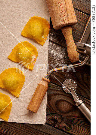 Raw homemade ravioli pasta with spinach and ricotta Raw homemade ravioli pasta with spinach and ricotta 76887122