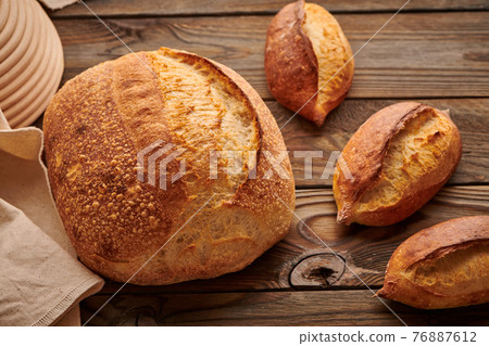 Homemade tartine bread on wooden table 76887612