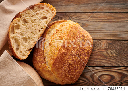 Homemade tartine bread on wooden table 76887614