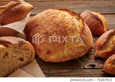 Homemade tartine bread on wooden table Homemade tartine bread on wooden table 76887632