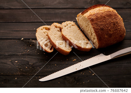 Homemade tartine bread on dark wooden table Homemade tartine bread on dark wooden table 76887642