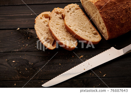 Homemade tartine bread on dark wooden table Homemade tartine bread on dark wooden table 76887643