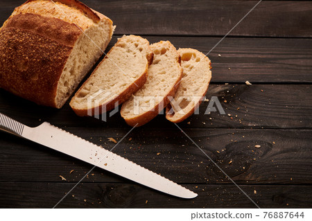 Homemade tartine bread on dark wooden table Homemade tartine bread on dark wooden table 76887644