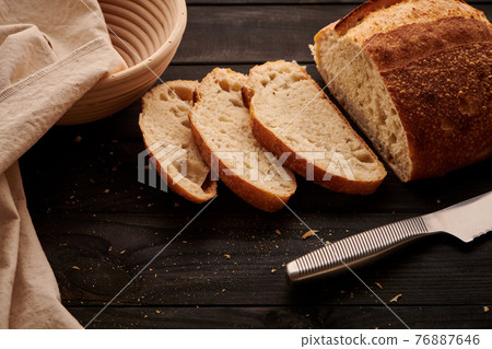 Homemade tartine bread on dark wooden table Homemade tartine bread on dark wooden table 76887646