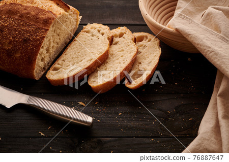 Homemade tartine bread on dark wooden table 76887647