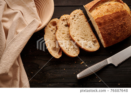 Homemade tartine bread on dark wooden table 76887648