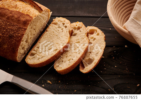 Homemade tartine bread on dark wooden table Homemade tartine bread on dark wooden table 76887655