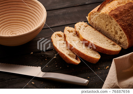 Homemade tartine bread on dark wooden table Homemade tartine bread on dark wooden table 76887656