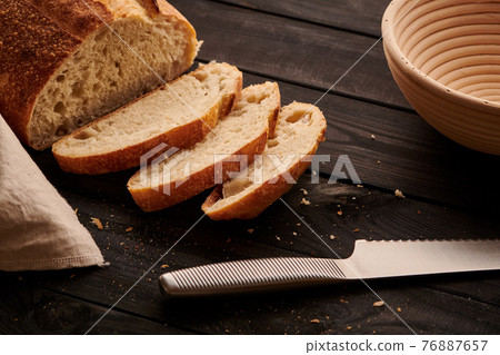 Homemade tartine bread on dark wooden table Homemade tartine bread on dark wooden table 76887657