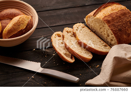 Homemade tartine bread on dark wooden table Homemade tartine bread on dark wooden table 76887660