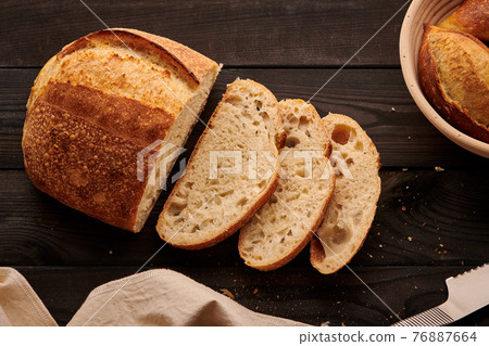 Homemade tartine bread on dark wooden table Homemade tartine bread on dark wooden table 76887664
