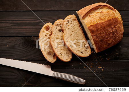 Homemade tartine bread on dark wooden table 76887669