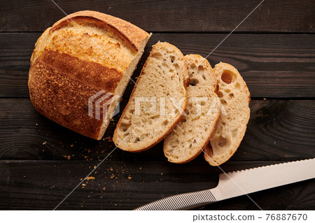 Homemade tartine bread on dark wooden table 76887670