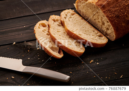 Homemade tartine bread on dark wooden table 76887679