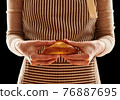 Baker holding homemade bun 76887695