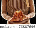 Baker holding homemade bun 76887696