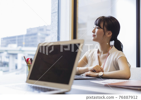 Woman thinking at the office desk Woman thinking at the office desk 76887912
