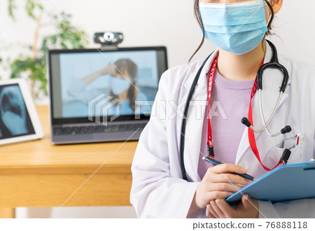 Young female doctor filling out a questionnaire Young female doctor filling out a questionnaire 76888118