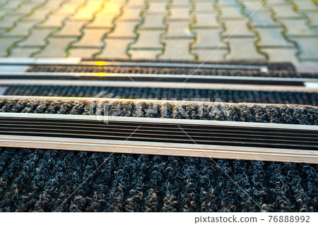 Closeup of ceramic tiles covering porch stairs with rubber anti slippery stripes on it. 76888992