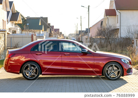 Frankfurt, Germany - September 27, 2020: New bright red Mercedes Benz C-class parked outside on a street. Frankfurt, Germany - September 27, 2020: New bright red Mercedes Benz C-class parked outside on a street. 76888999