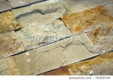 Closeup detail of limestone tiled wall of floor. Closeup detail of limestone tiled wall of floor. 76889346