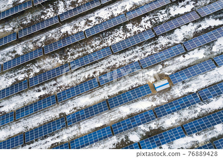 Blue solar photo voltaic panels system producing renewable clean energy in rural area in winter. 76889428