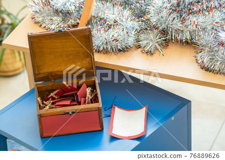 Small wooden gift box with red greeting cards inside. Small wooden gift box with red greeting cards inside. 76889626