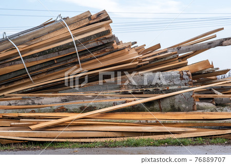 Stack od wooden boards prepared for cutting by chainsar for firewood. Stack od wooden boards prepared for cutting by chainsar for firewood. 76889707