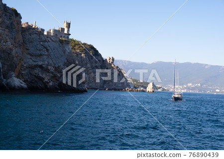 Beautiful landscape with yachts on the sea against the background of the Swallows Nest - an ancient Beautiful landscape with yachts on the sea against the background of the Swallows Nest - an ancient 76890439