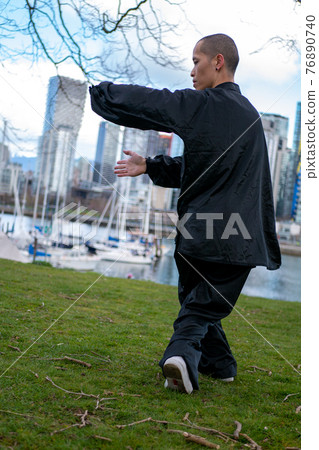 Chinese man dancing Tai Chi in the park (whole body, vertical photo) Chinese man dancing Tai Chi in the park (whole body, vertical photo) 76890740