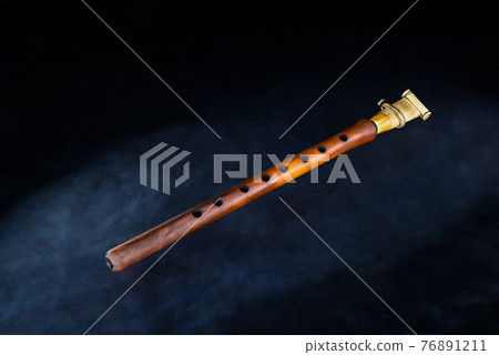 Armenian musical woodwind instrument duduk or tsiranapogh on isolated black background 76891211