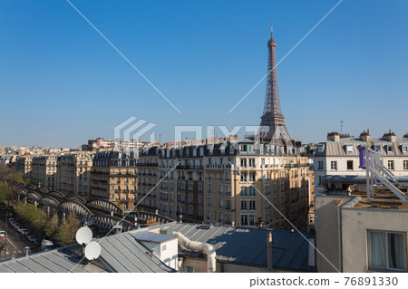 Eiffel tower behind the houses. Paris, France. 76891330