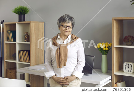 Smiling senior female office worker career professional businesswoman portrait 76891566