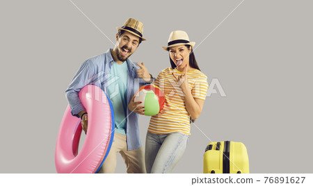 Portrait funky crazy couple with luggage beach accessory celebrate vacation time Portrait funky crazy couple with luggage beach accessory celebrate vacation time 76891627