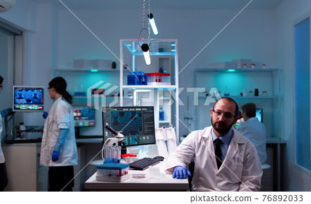 Portrait of man scientist in research laboratory looking at the camera Portrait of man scientist in research laboratory looking at the camera 76892033