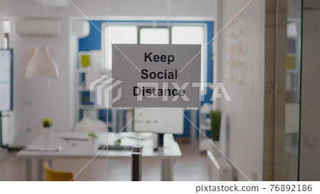 Business glass interior office with keep social distance sign 76892186