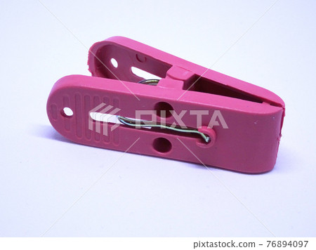 Red plastic clothespin isolated on white background  76894097