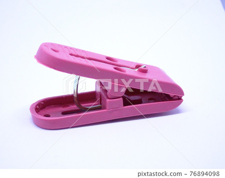 Red plastic clothespin isolated on white background Red plastic clothespin isolated on white background 76894098
