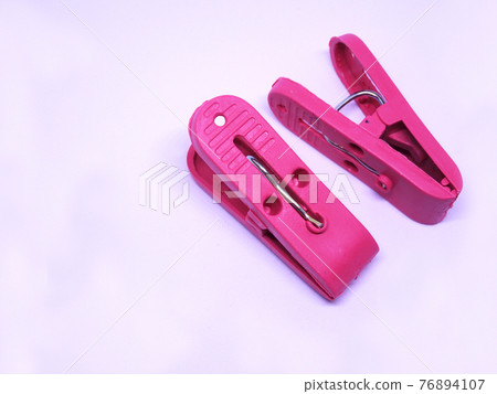 Red plastic clothespin isolated on white background  76894107