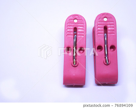 Red plastic clothespin isolated on white background  76894109