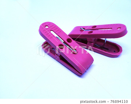 Red plastic clothespin isolated on white background  76894110