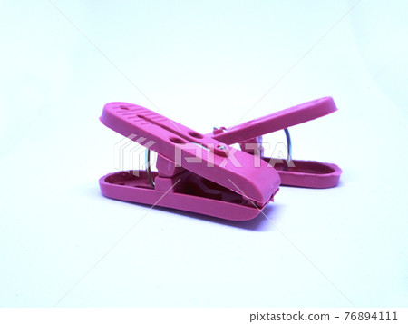 Red plastic clothespin isolated on white background  76894111