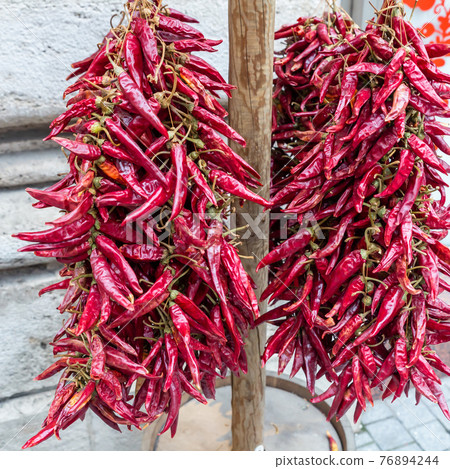 chili peppers sun drying, garland outdoor traditional way chili peppers sun drying, garland outdoor traditional way 76894244